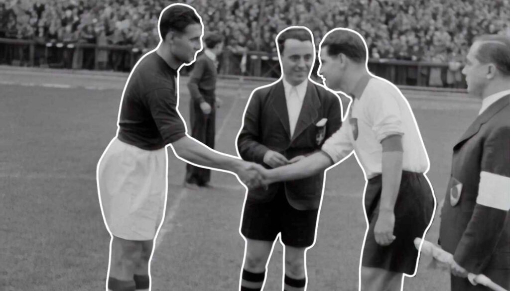 Old footballers shaking hands before kick off.
