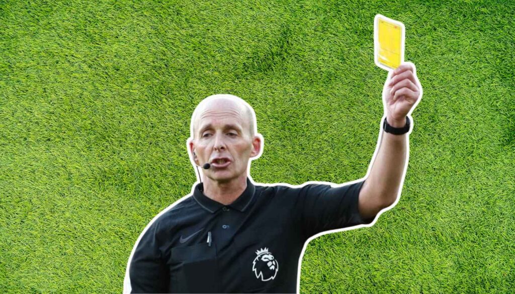 Mike Dean giving a yellow card